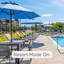 Resort-style swimming pool with lounge seating