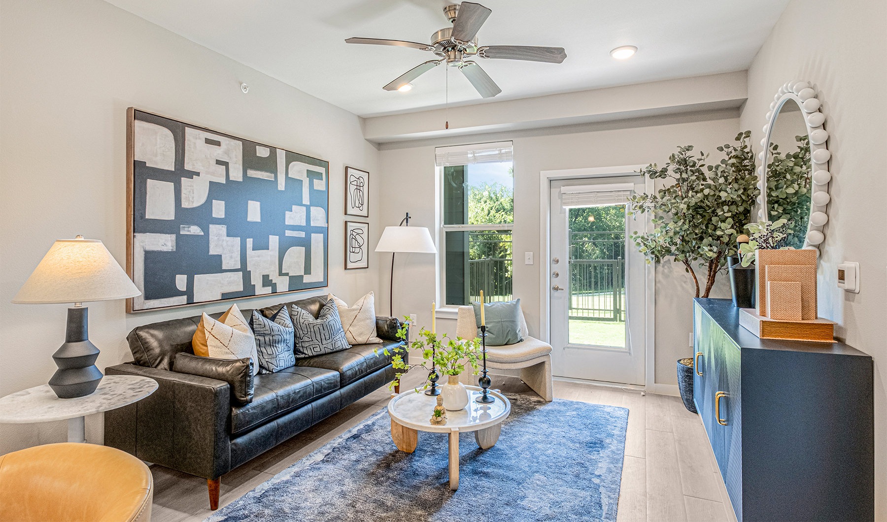 Generous living spaces with beautiful natural lighting a living room with a white couch table and large window