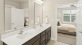 a bathroom with sinks and a mirror