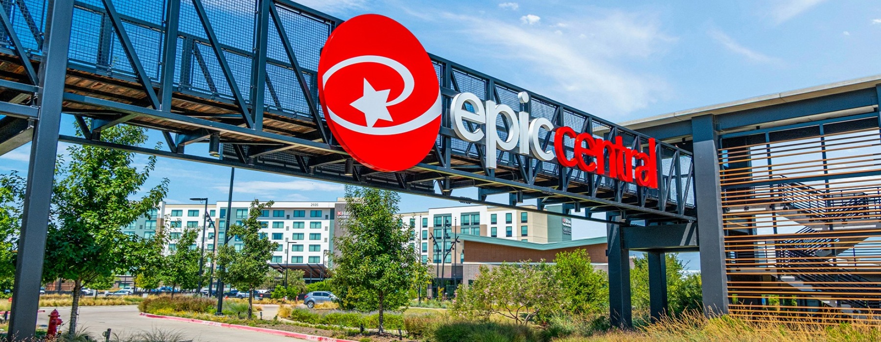 EpicCentral entrance sign and pedestrian bridge with Hilton Garden Inn in the background, Grand Prairie, Texas.