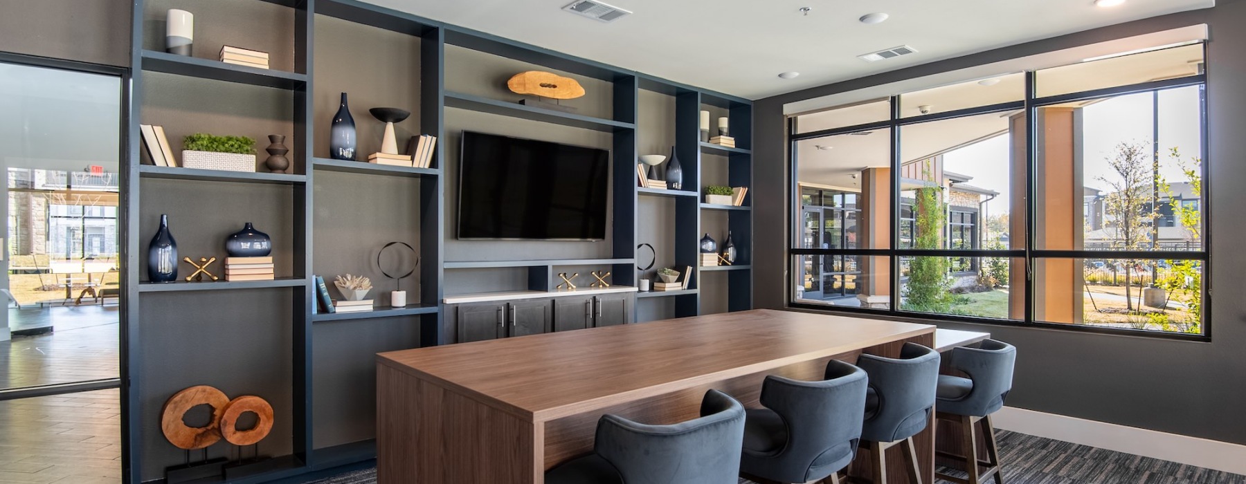 lounge with windows seating island and tv