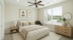 a bedroom with a bed fan dresser mirror and window